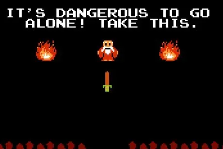 An 8-bit pixel art scene from the original NES game "The Legend of Zelda." Against a black background, a small old man in orange robes stands between two flickering fires. A pixelated wooden sword floats in front of him. Above the characters, white block text reads: "IT'S DANGEROUS TO GO ALONE! TAKE THIS."